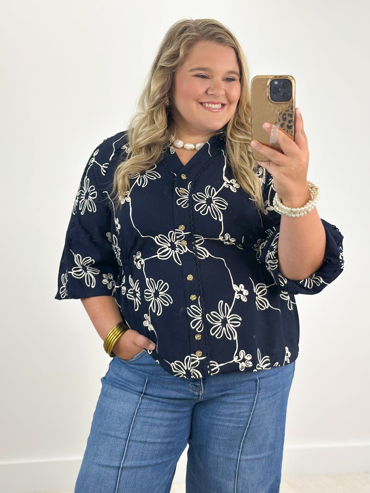 Navy floral button-detail blouse with half sleeves and V-neck