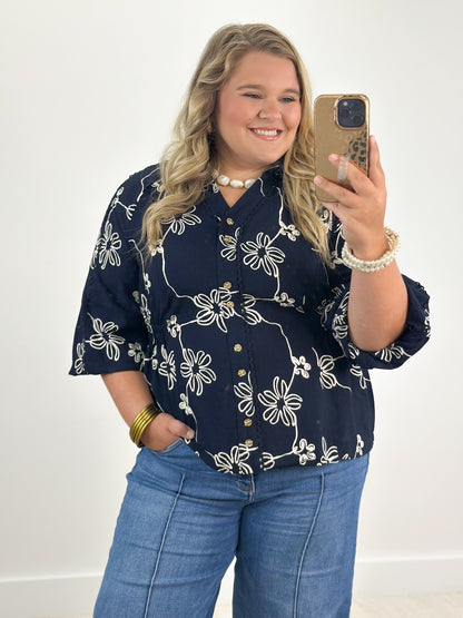 Navy floral button-detail blouse with half sleeves and V-neck