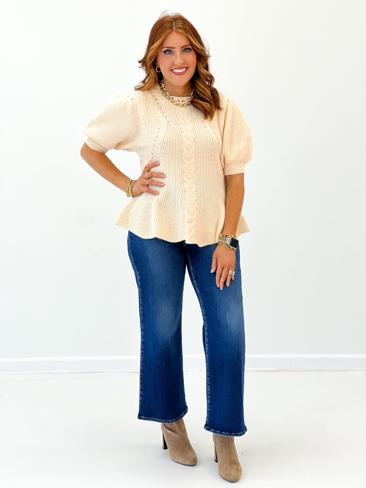 Ivory knit sweater top with round neck, short sleeves, peplum-style flare hem