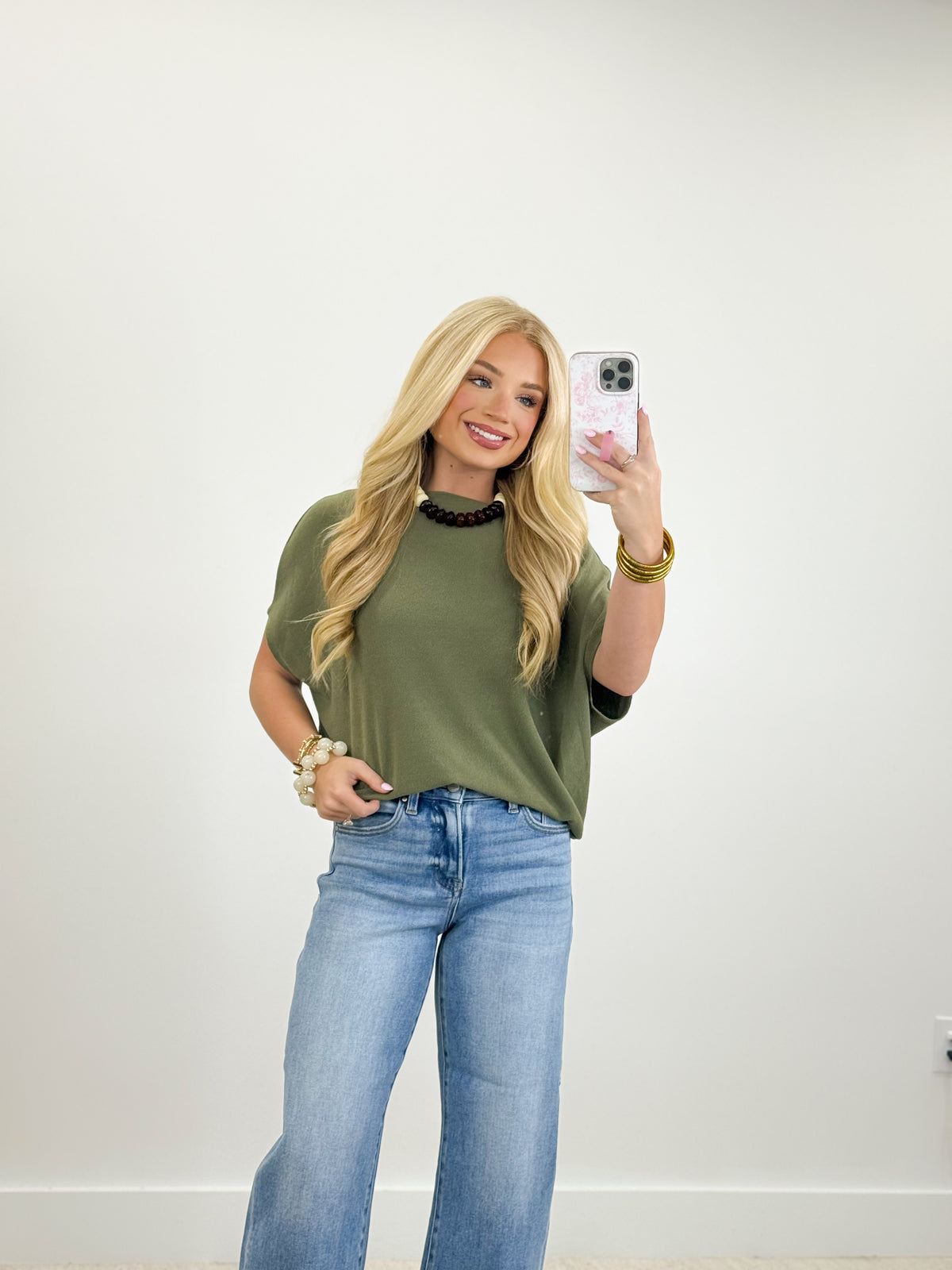 Olive green short-sleeve dolman top with black neck trim
