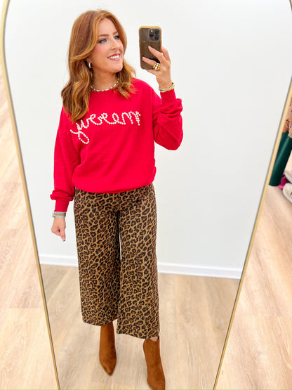 Cropped leopard-print pants with wide, flowy legs and elastic waistband