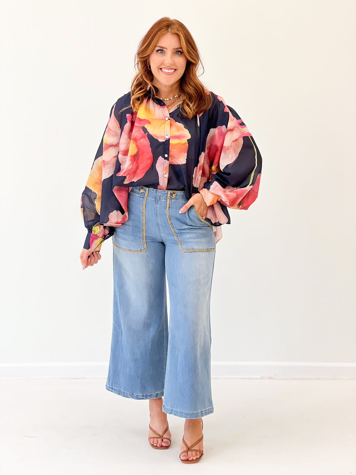 Navy floral print blouse with wide sleeves and button front, V-neck style