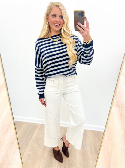 Navy and white striped off-shoulder sweater with long sleeves