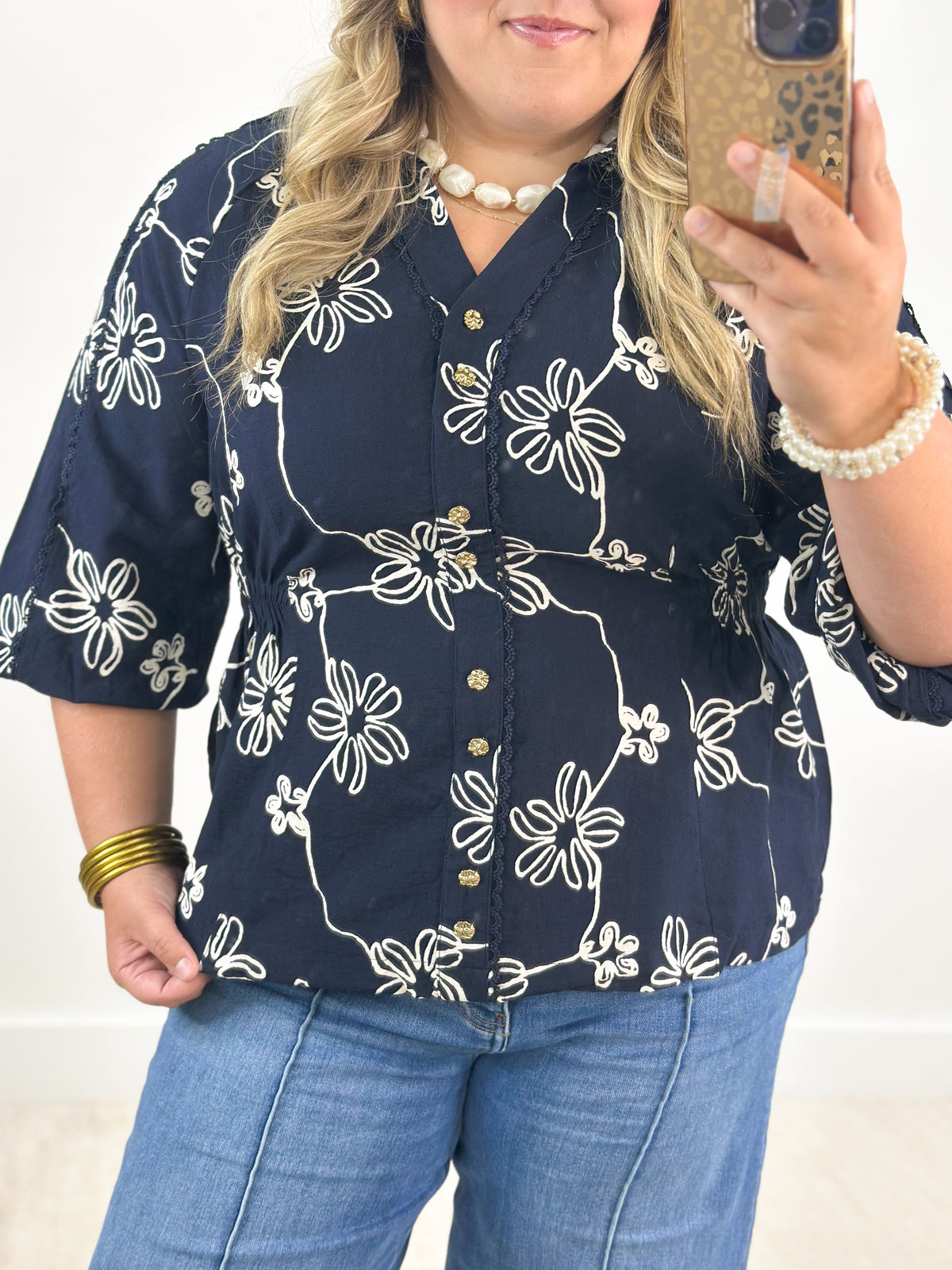 Navy floral printed button-detail top with small front buttons and V-neck