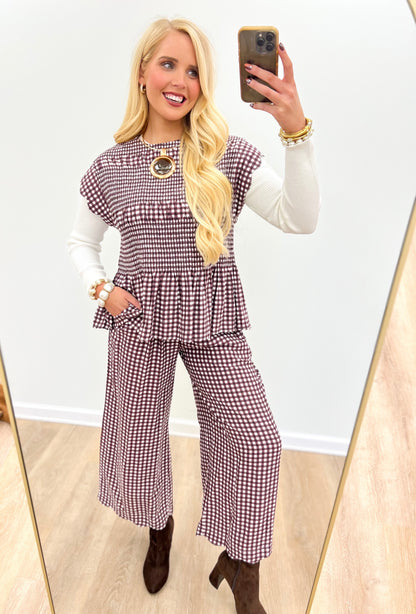 Purple gingham smocked peplum top with scalloped sleeves and circular neckline detail