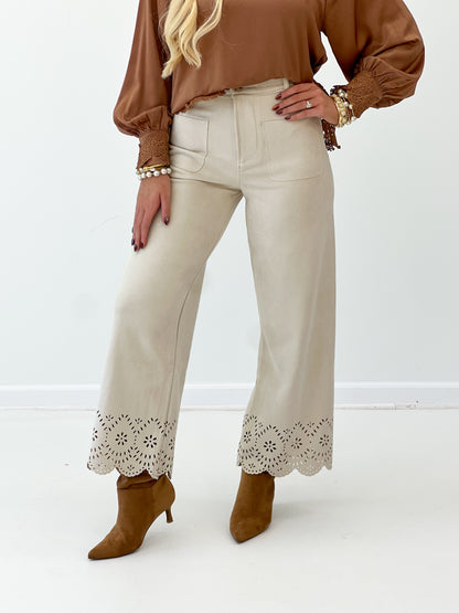 Bone suede wide-leg pants with laser-cut eyelet hems and front pockets