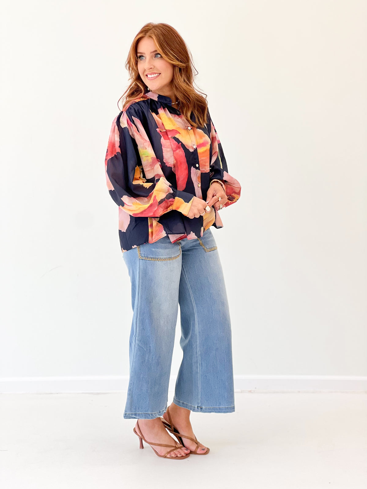 Navy floral print blouse with gathered voluminous sleeves and button front detail