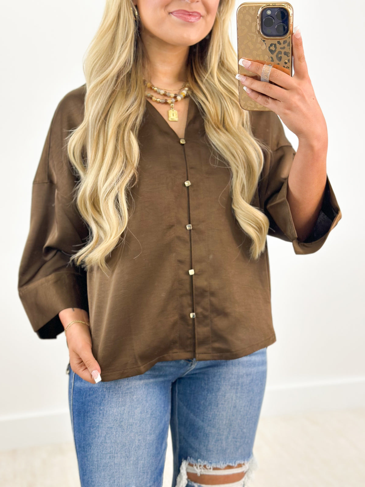 Brown V-neck button-down shirt with metal buttons and down collar