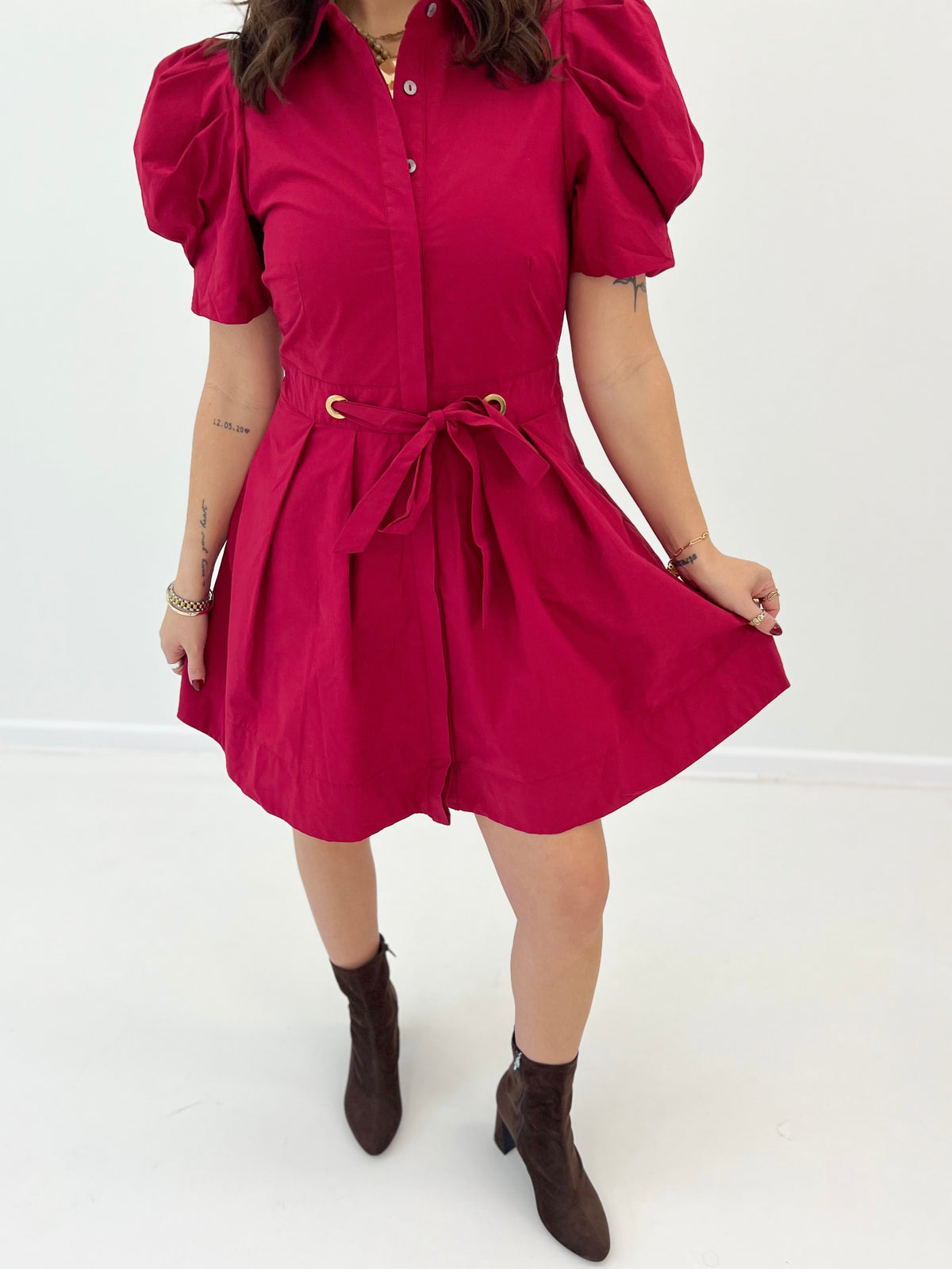 Scarlet puff sleeve tie-waist pleated mini dress, close-up of front buttons