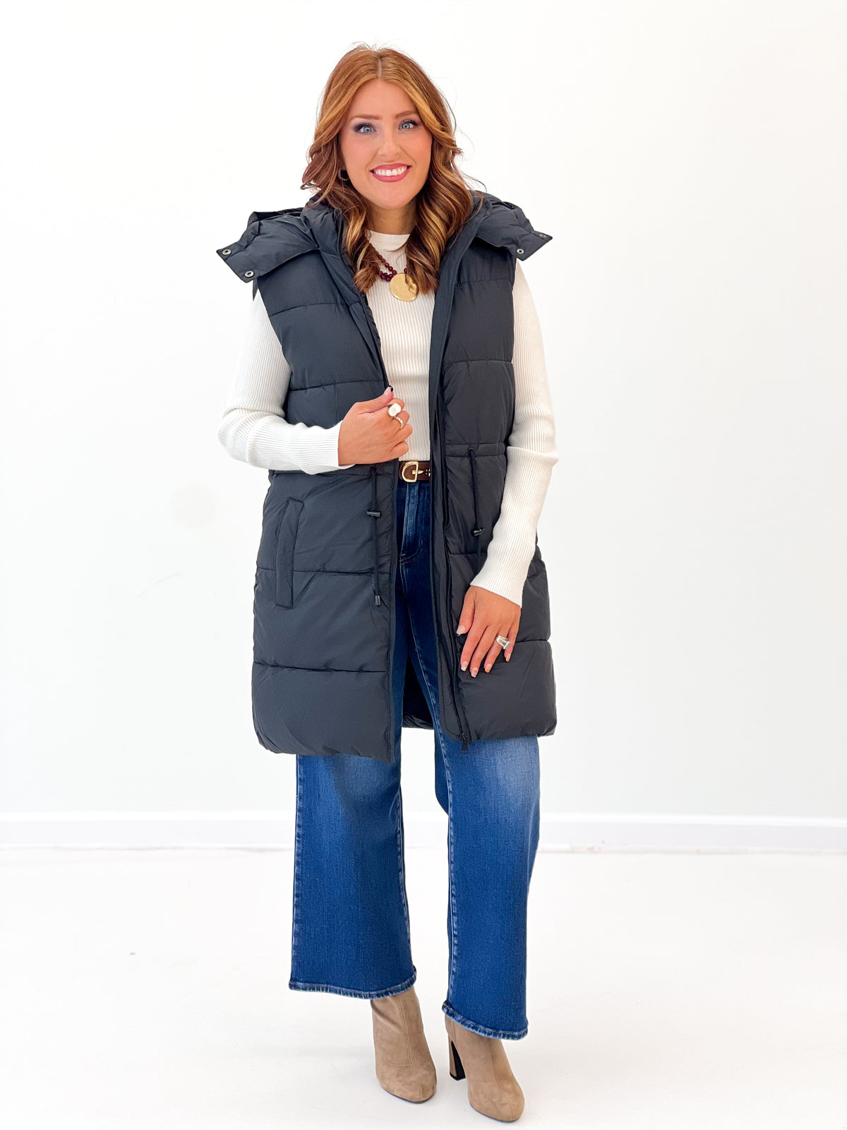 Longline quilted puffer vest in dark black with side pockets and open front