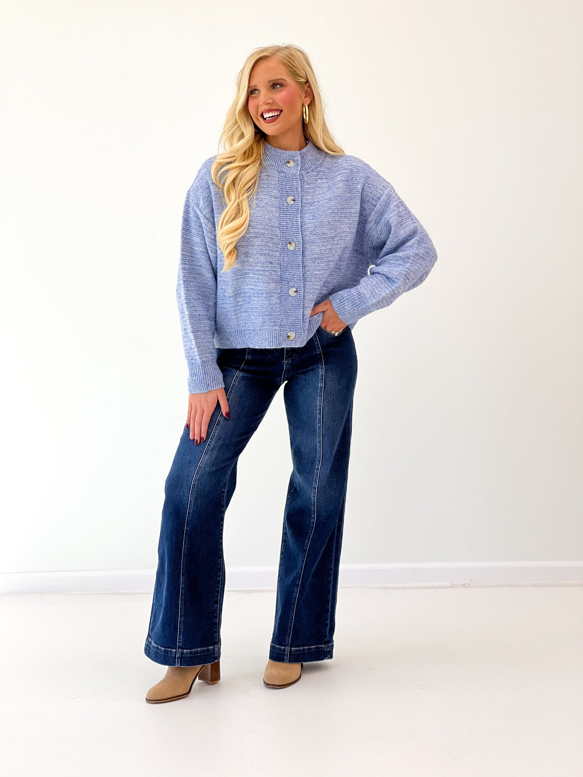 Denim blue marled knit cardigan with button front and ribbed trim at collar and cuffs.