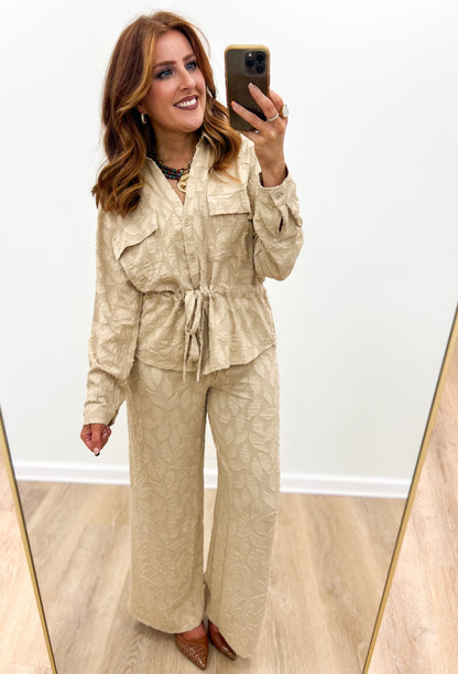 Taupe utility tie-waist top with button front, long sleeves, and chest pockets