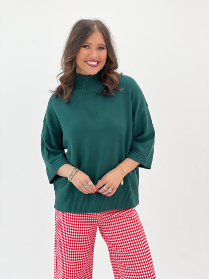 Hunter green knit mock neck short-sleeve sweater, ribbed neckline and cuffs