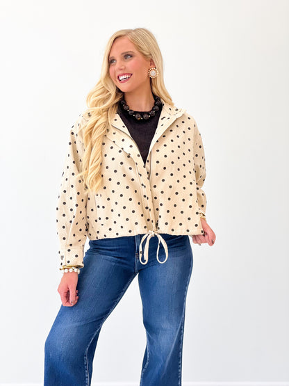 Ecru polka dot tie-front jacket with stand collar and button front, drawstring waist