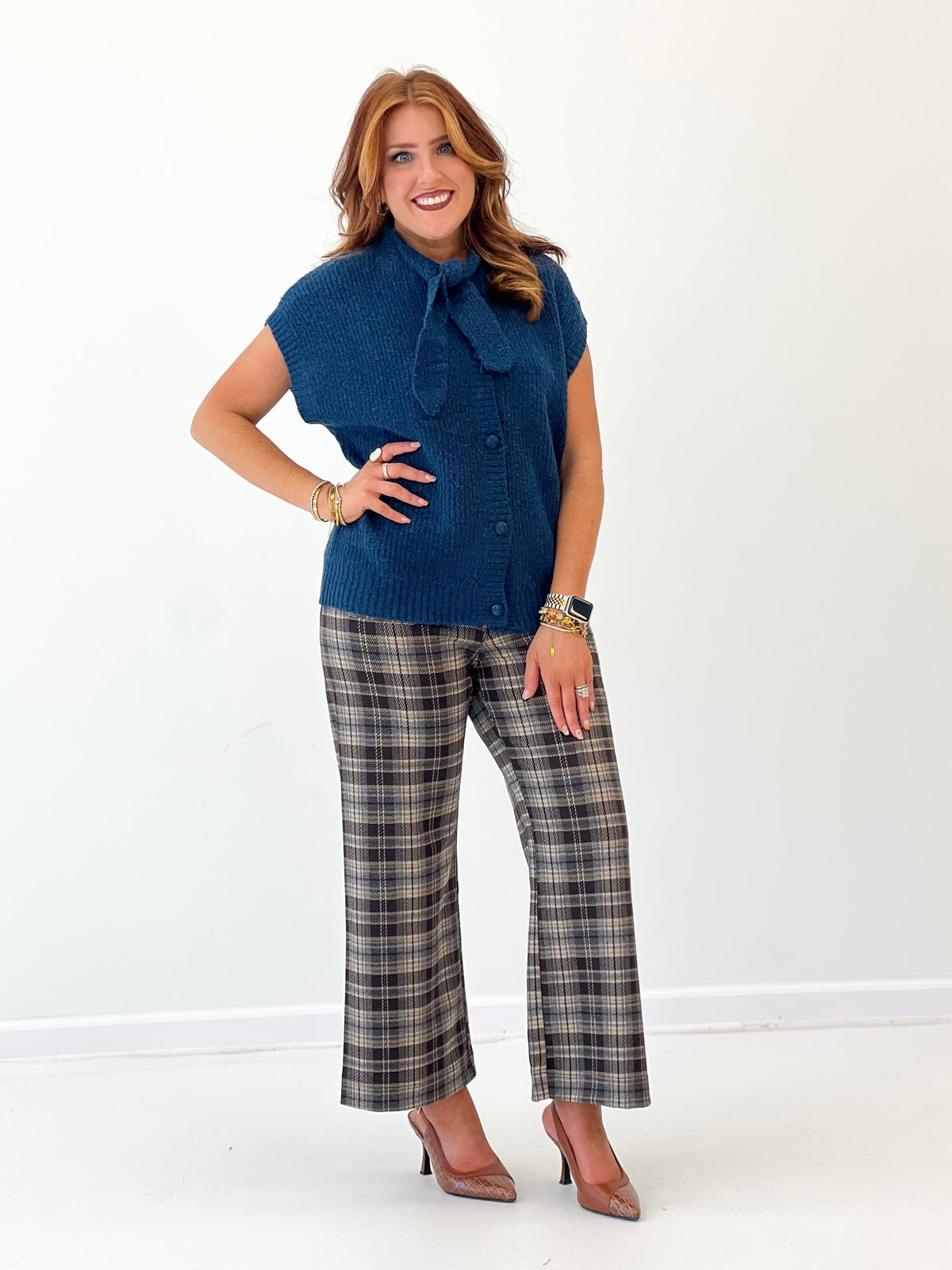 Teal knit sweater vest with bow collar detail and front buttons, short sleeves