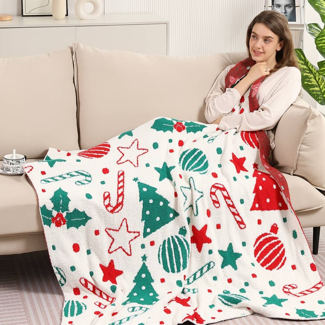 Cream throw blanket with red and green Christmas print