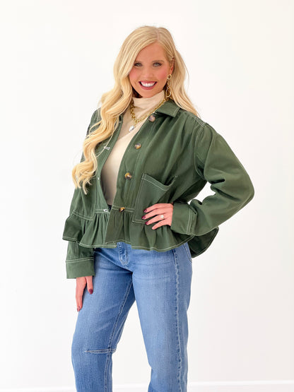 Olive denim jacket with chest pocket, peplum ruffle hem, and button front