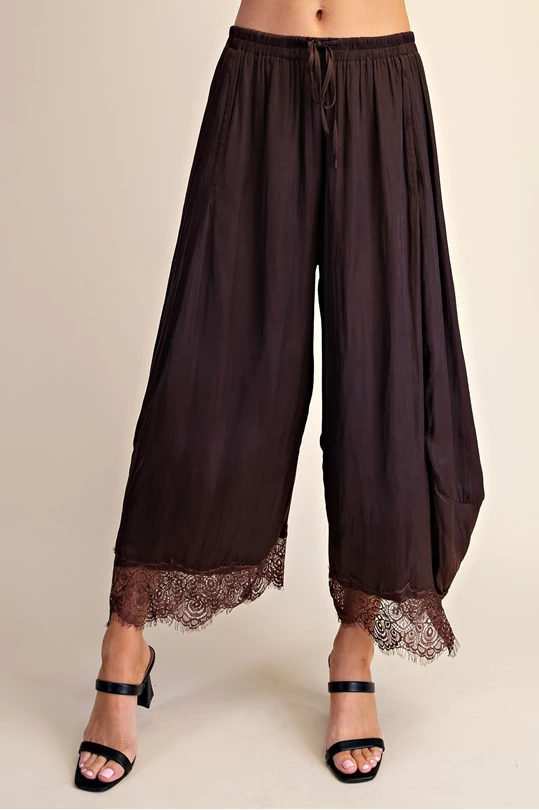 Brown cropped wide leg pants with lace hem and drawstring waist, front view