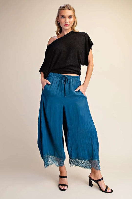 Teal cropped wide leg pants with lace hem styled with a black top