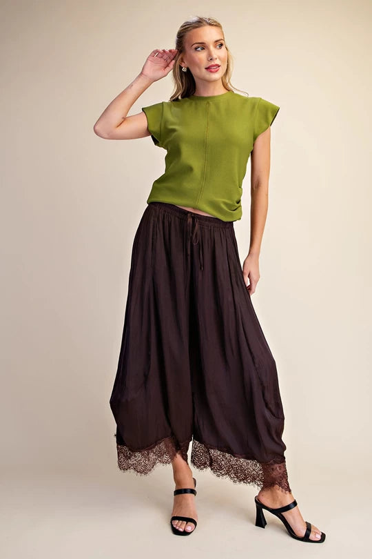Brown cropped wide leg pants with lace hem styled with a green top