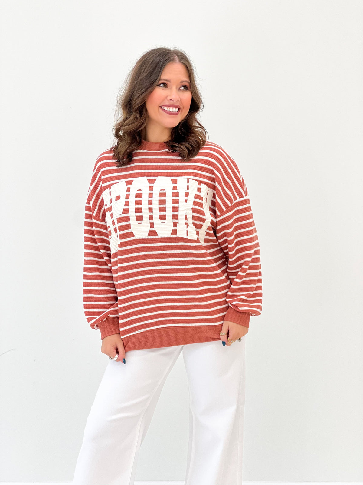 Rust red and white striped knit top, long sleeves, spooky graphic, crew neck