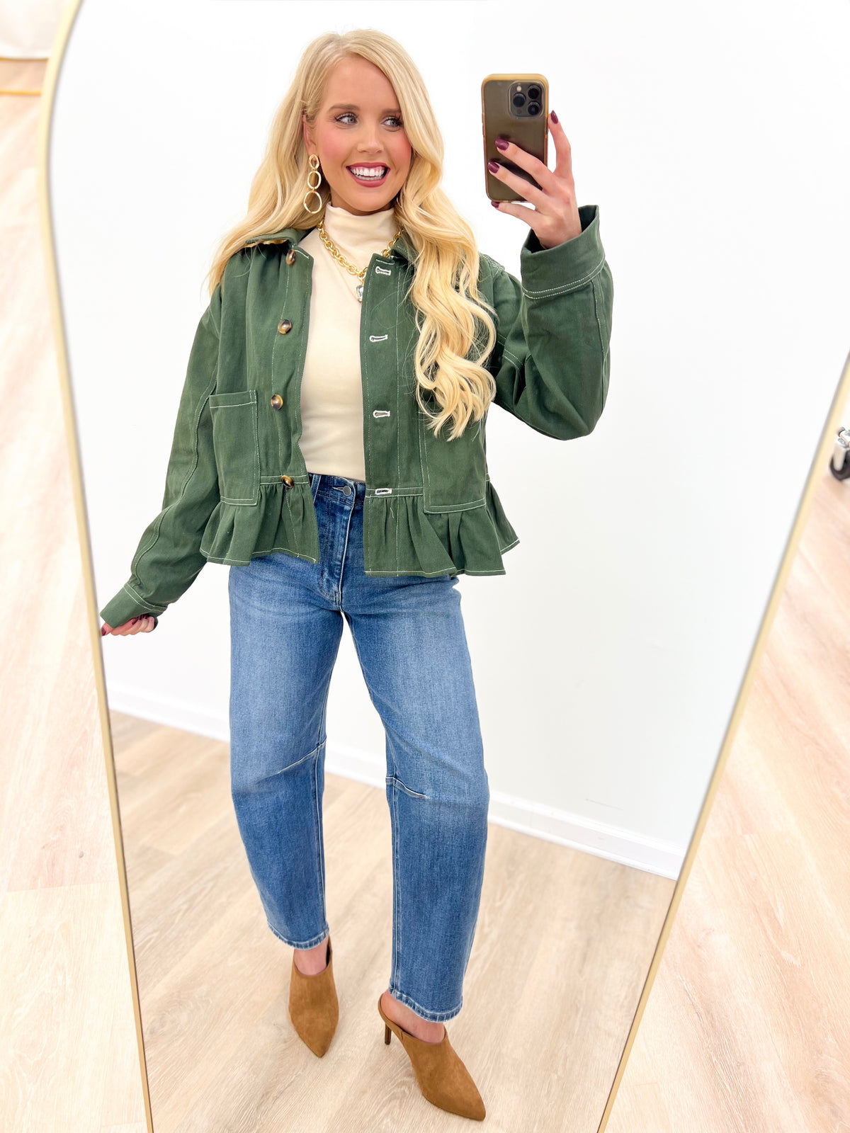 Olive denim jacket with ruffled peplum hem, button front, and chest pockets