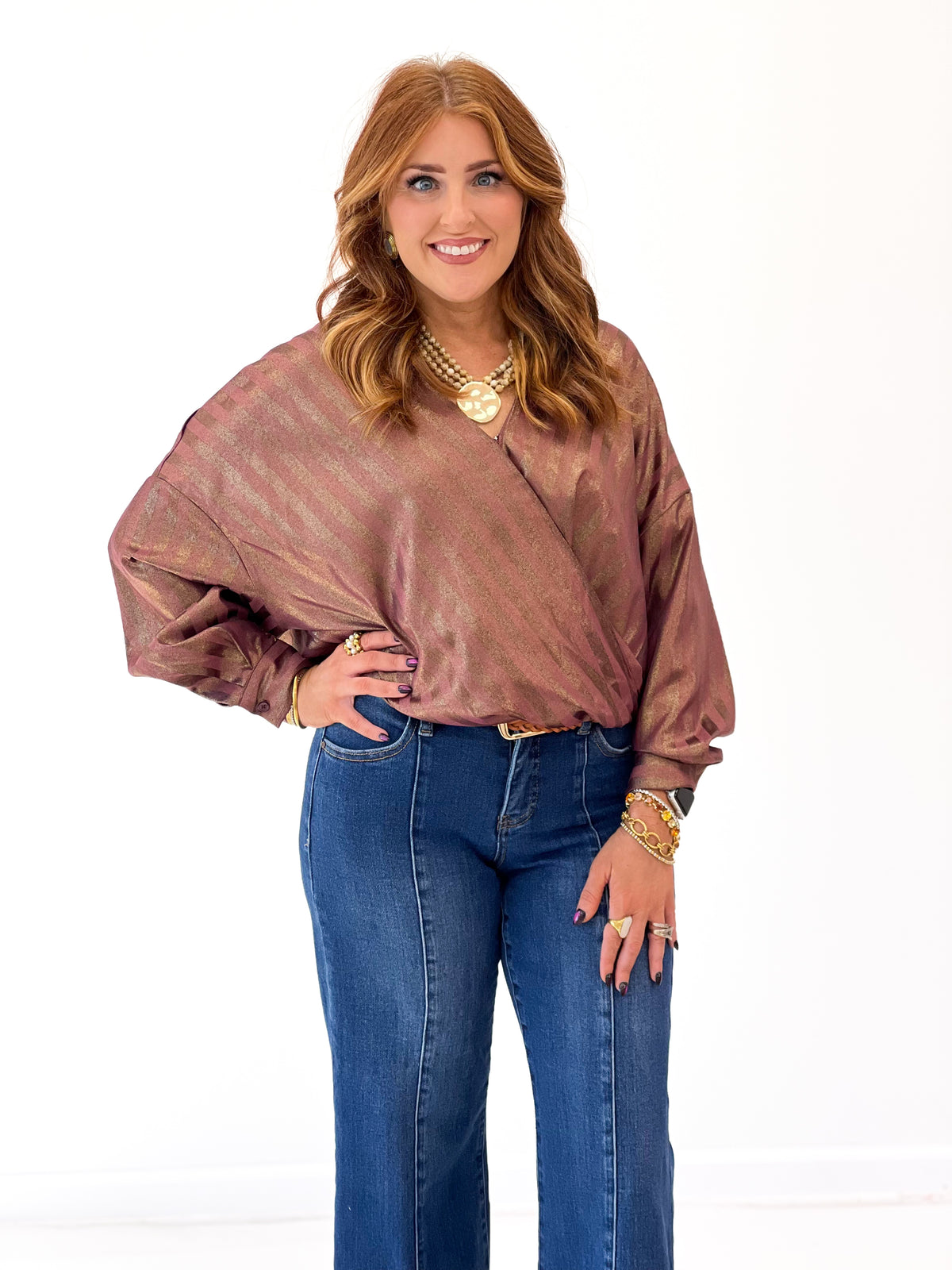 Burgundy metallic stripe V-neck wrap blouse with billowy sleeves and ruched waist detail