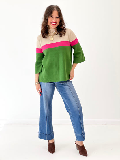 Color-block mock neck sweater in beige, green, and pink with wide sleeves