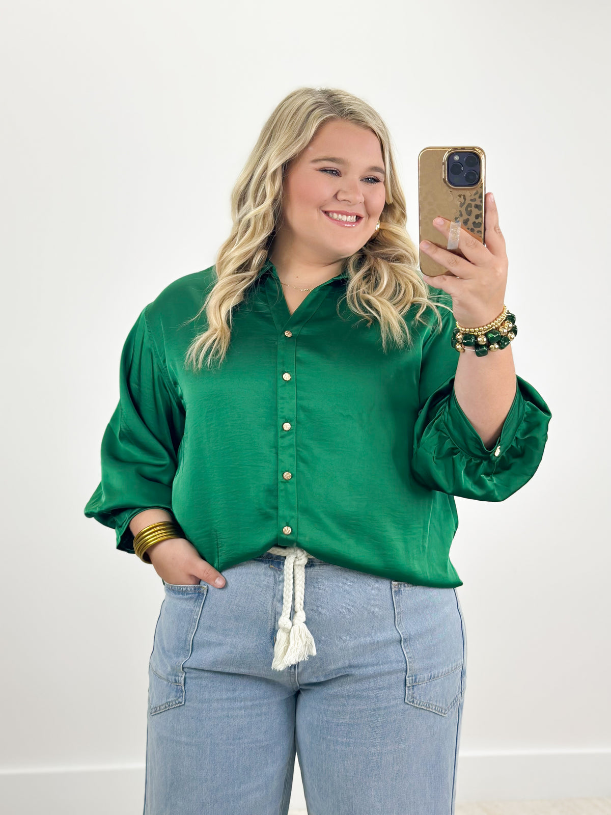 Green button-front shirt with elbow-length puff sleeves and tassel hem detail