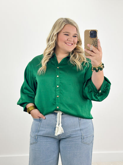Green button-front shirt with elbow-length puff sleeves and tassel hem detail
