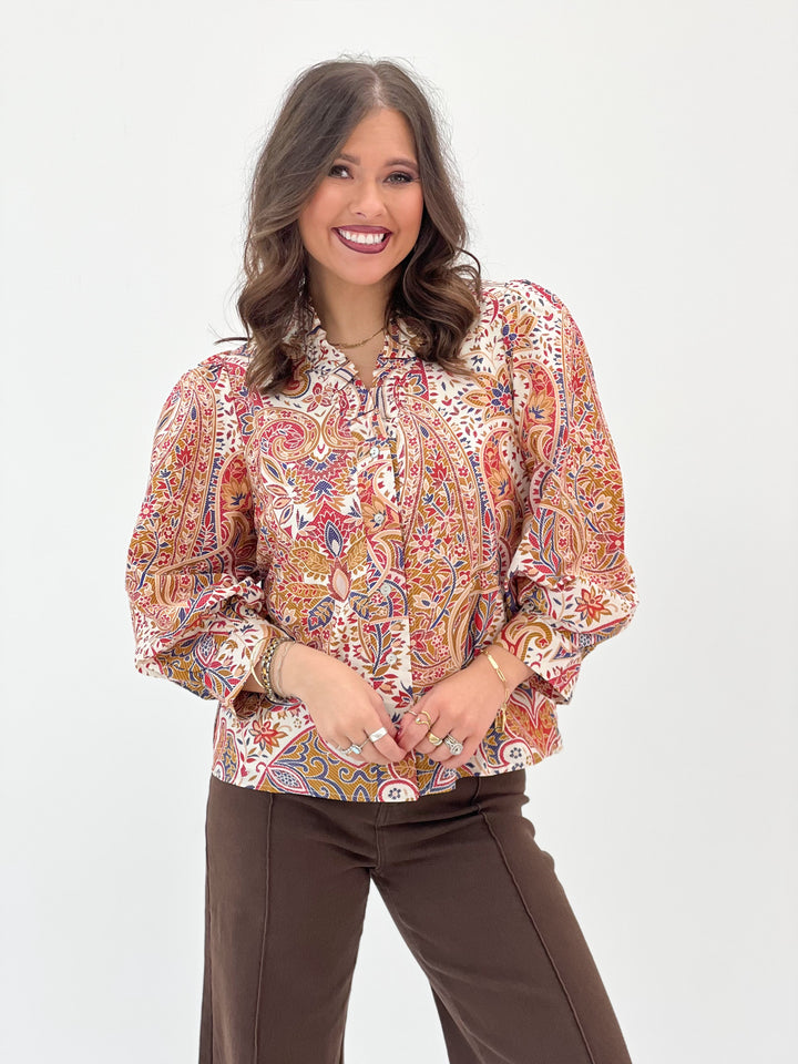Cream floral ruffle-neck button-down blouse with long puff sleeves