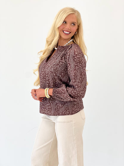 Brown printed V-neck long-sleeve top with keyhole neckline and cuff trim