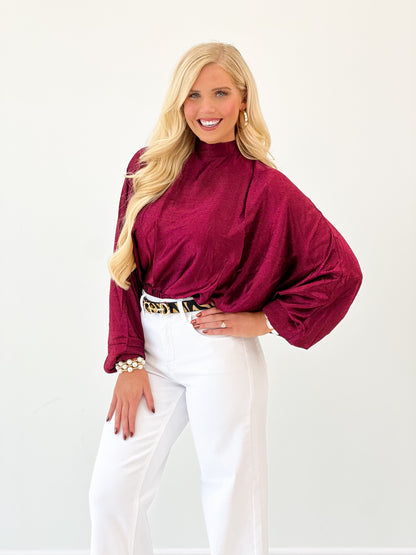Burgundy polka dot high-neck blouse with gathered neckline and puff sleeves