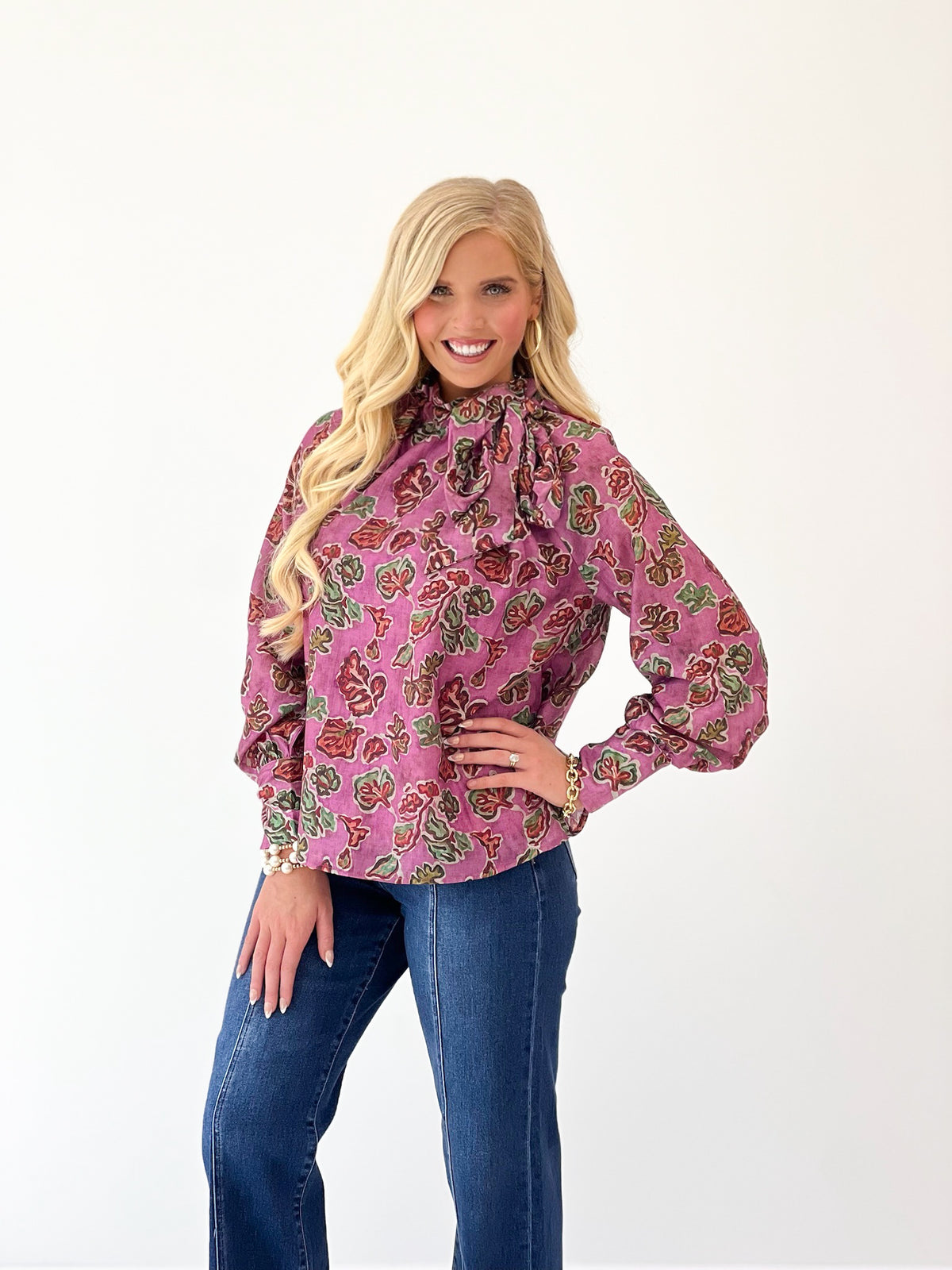 Pink printed tie-neck blouse with ruffled collar and long sleeves