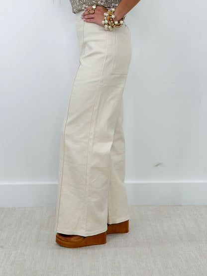 Off-white front-seam wide-leg pants with relaxed straight-leg fit