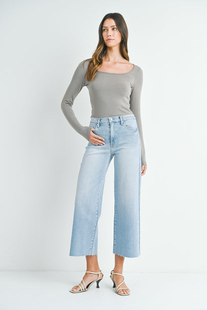 Light denim scissor cut wide leg jeans with a raw hem