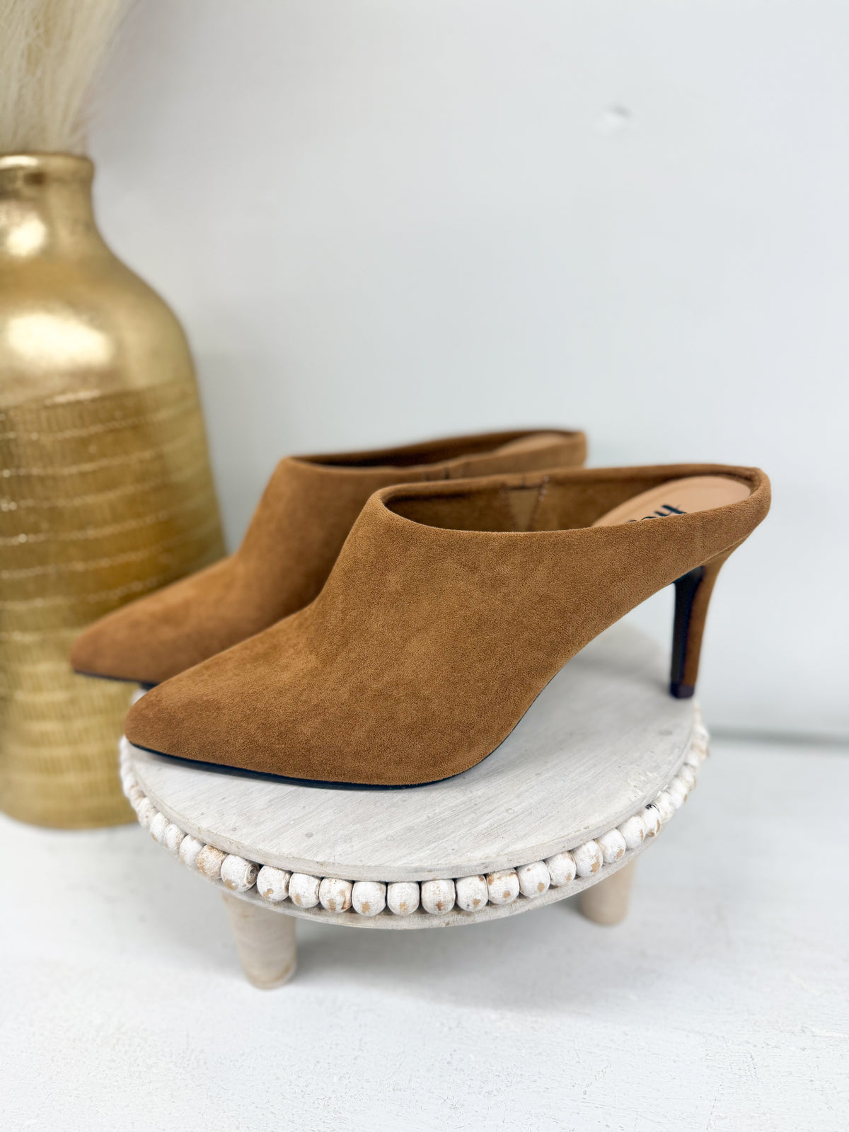 Camel suede slip-on mule with pointed toe, kitten heel, and beaded sole