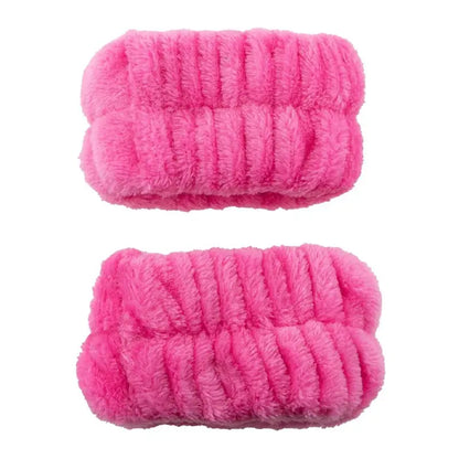 Two hot pink plush spa wristbands with gathered elastic texture