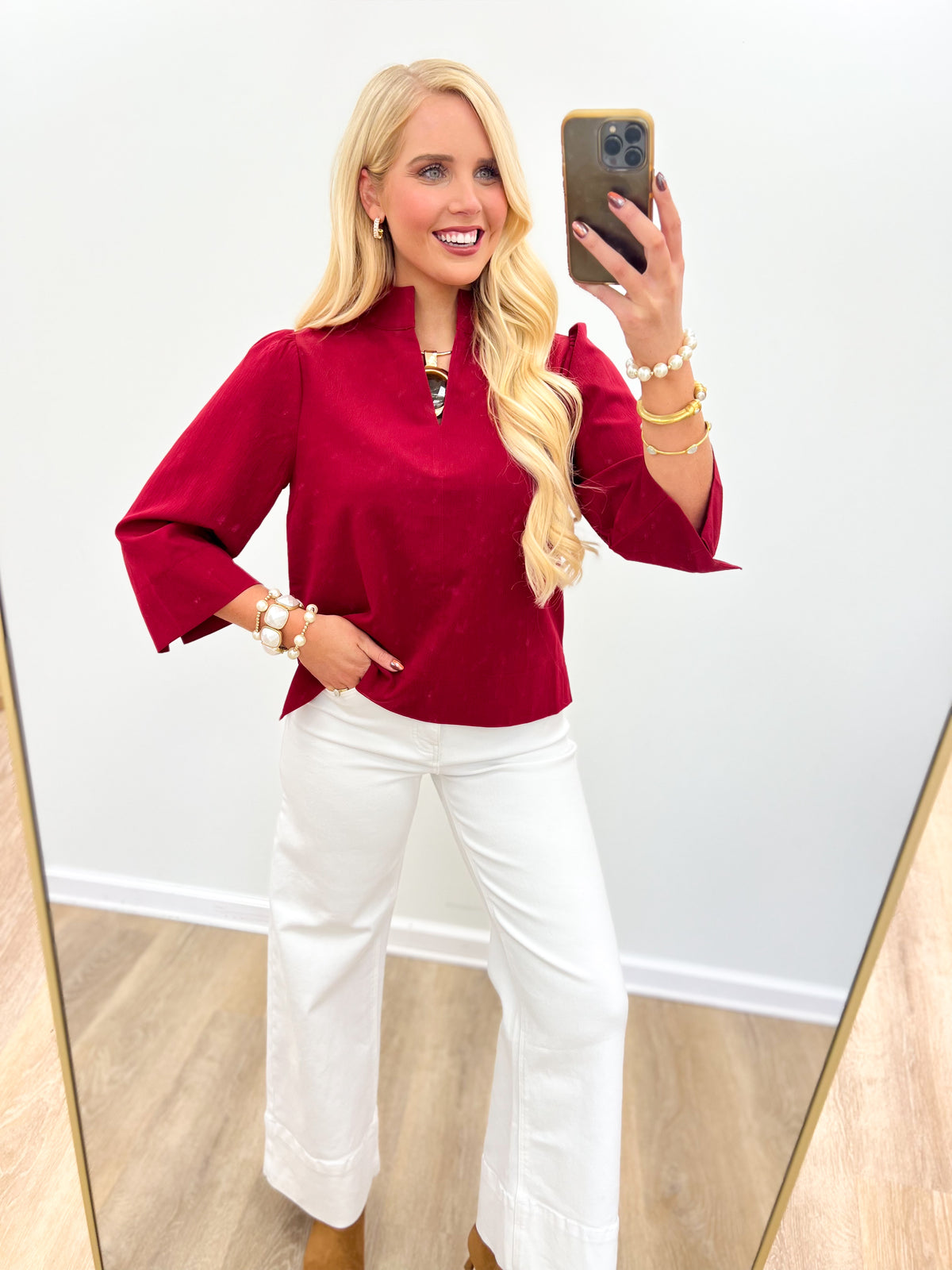 Burgundy textured V-neck top with elbow-length sleeves and button keyhole