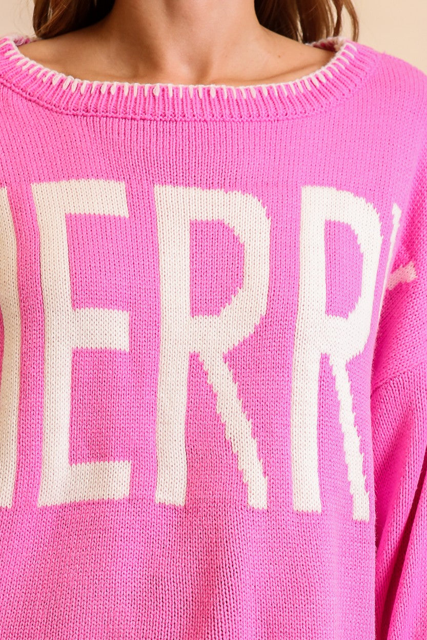 Timing Merry Festive And Chic Holiday Sweater in Pink, styled with denim shorts