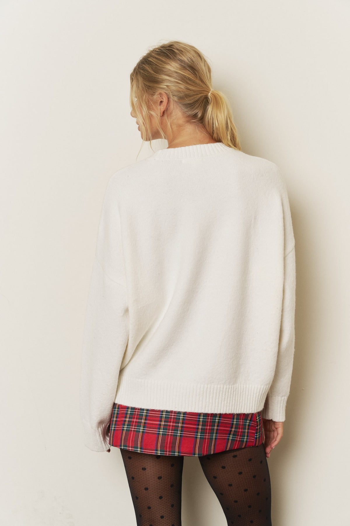 Blu Pepper Fa La La Christmas sweater in oatmeal, styled with plaid skirt