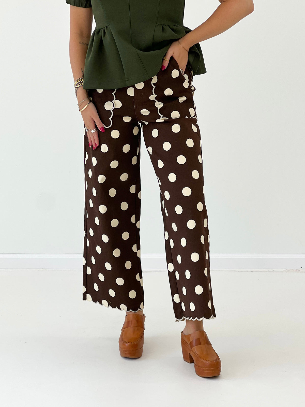 Brown polka dot wide-leg pants with scalloped hem