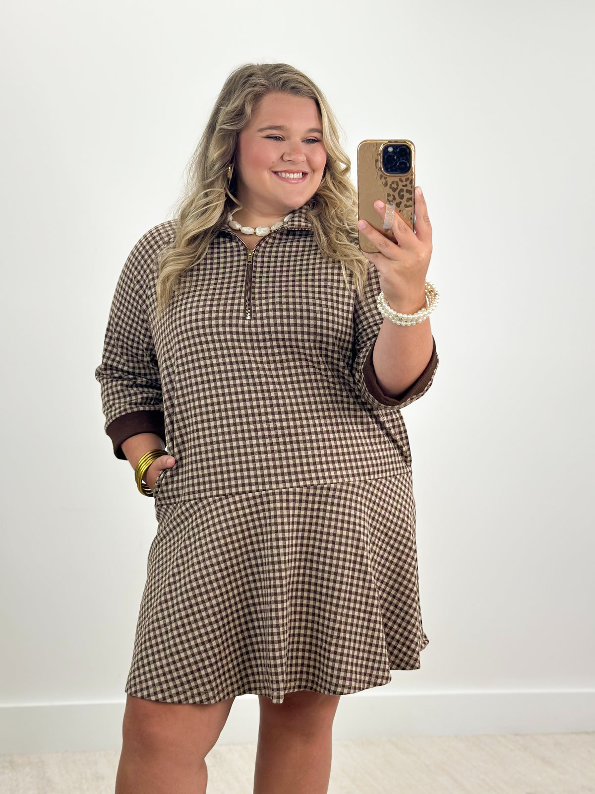 Brown check half-zip dress with long sleeves and gathered swing skirt