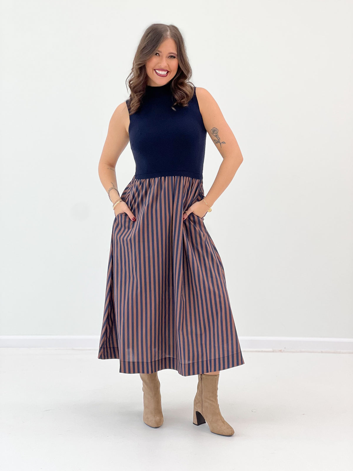 Navy sleeveless midi dress, high neck bodice with pleated striped skirt