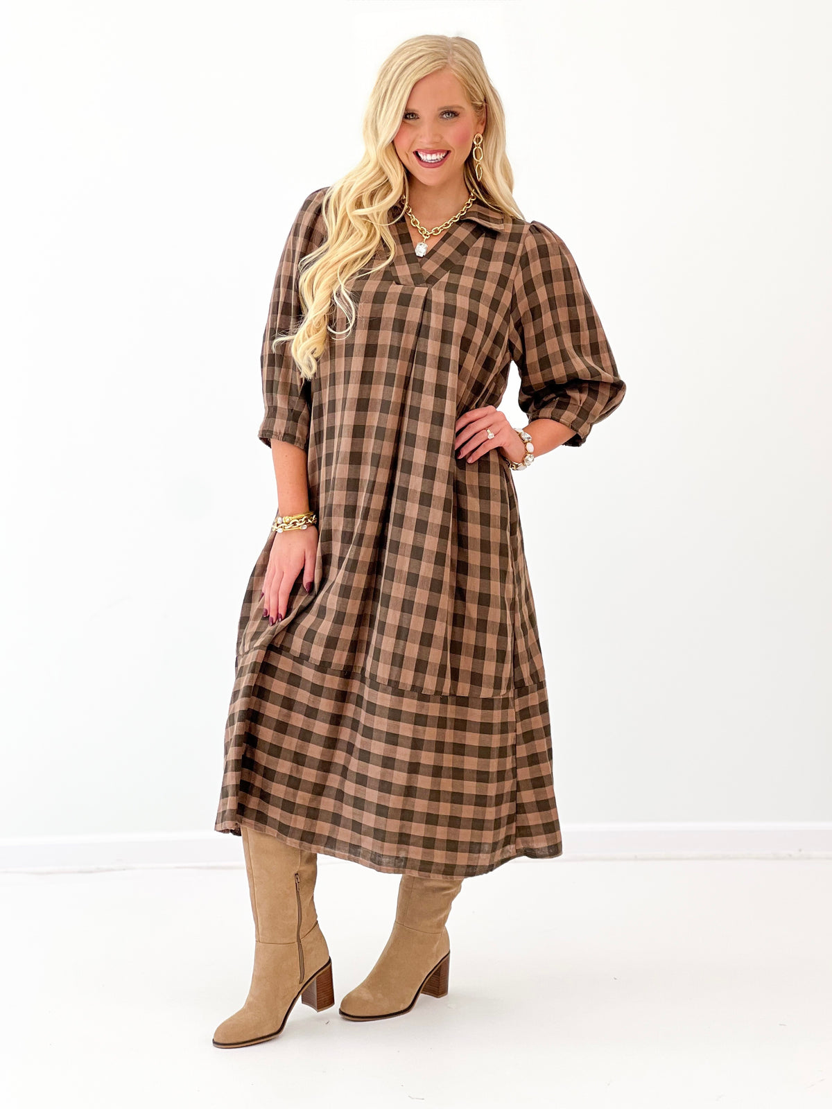 Brown-and-black checkered midi dress with open collar and roomy, draped fit
