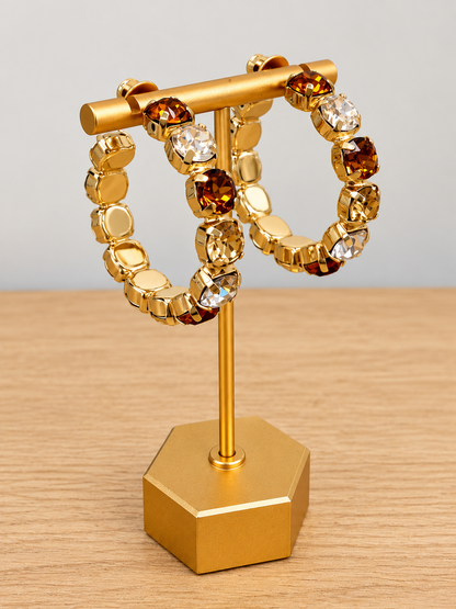 Gold-tone gemstone hoop earrings with amber and clear bead stones, side view
