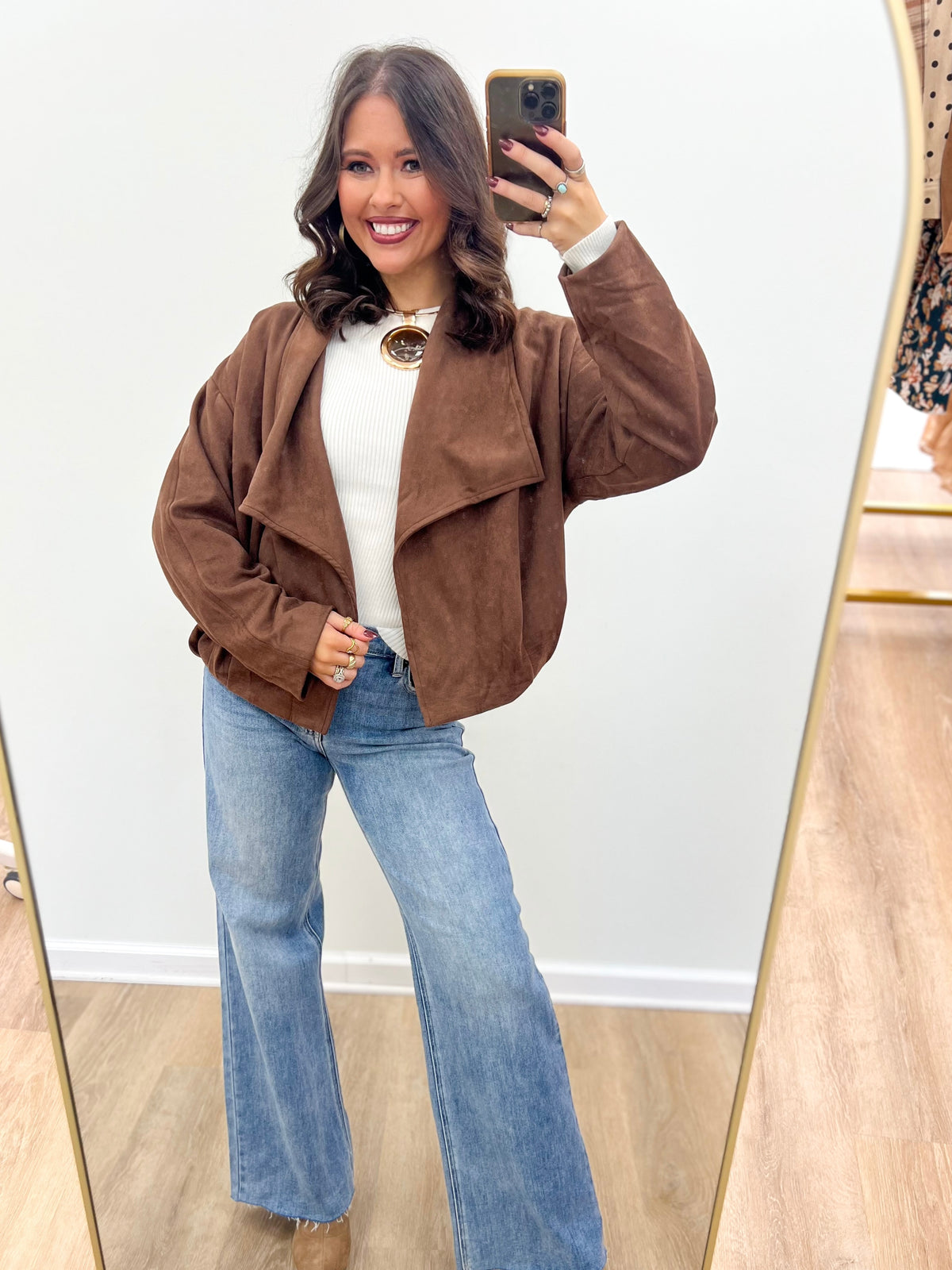 Brown suede collared jacket with open front and two chest pockets