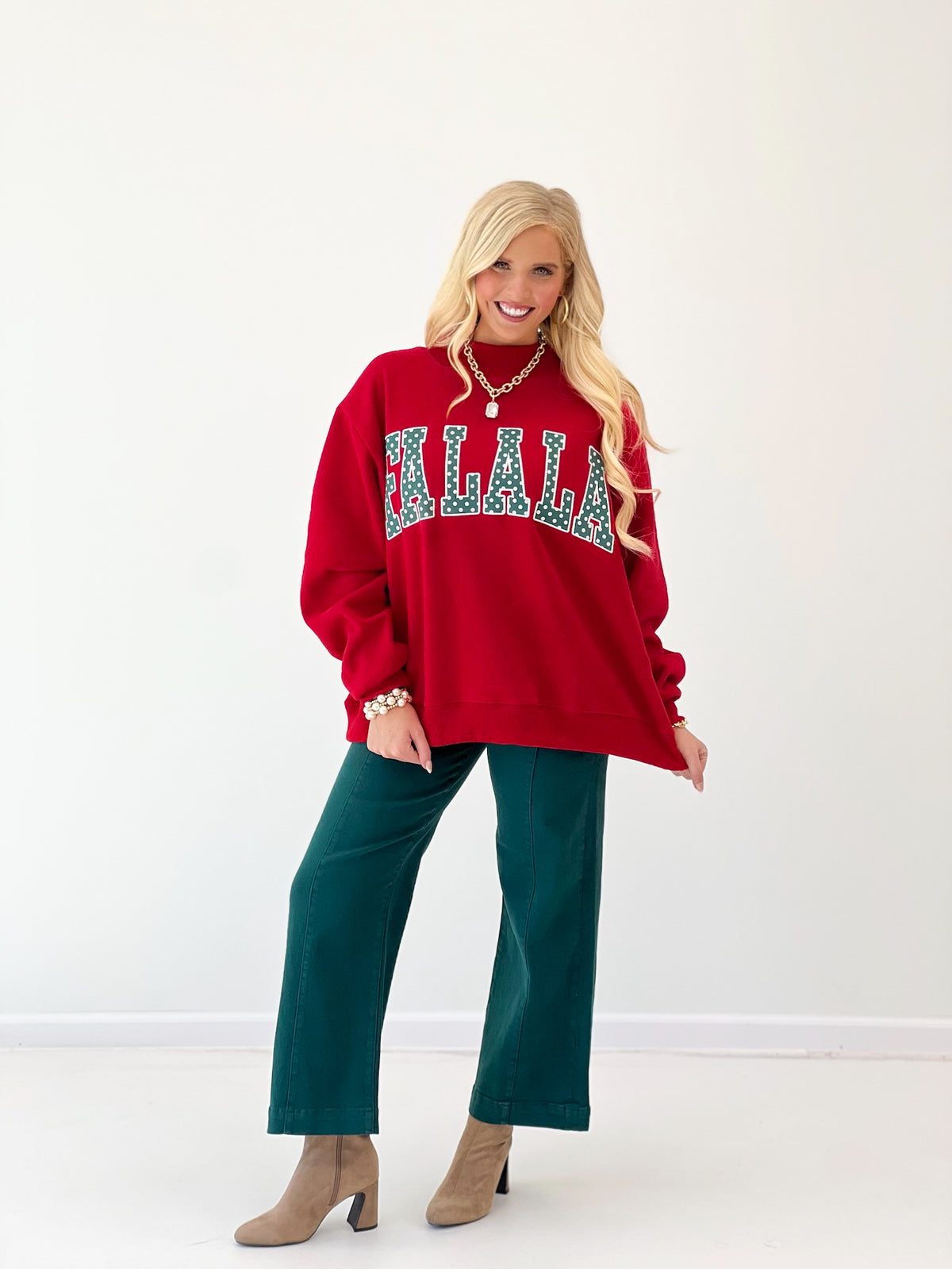 Red mock-neck sweatshirt with teal polka-dot 'FALALA' applique, long sleeves