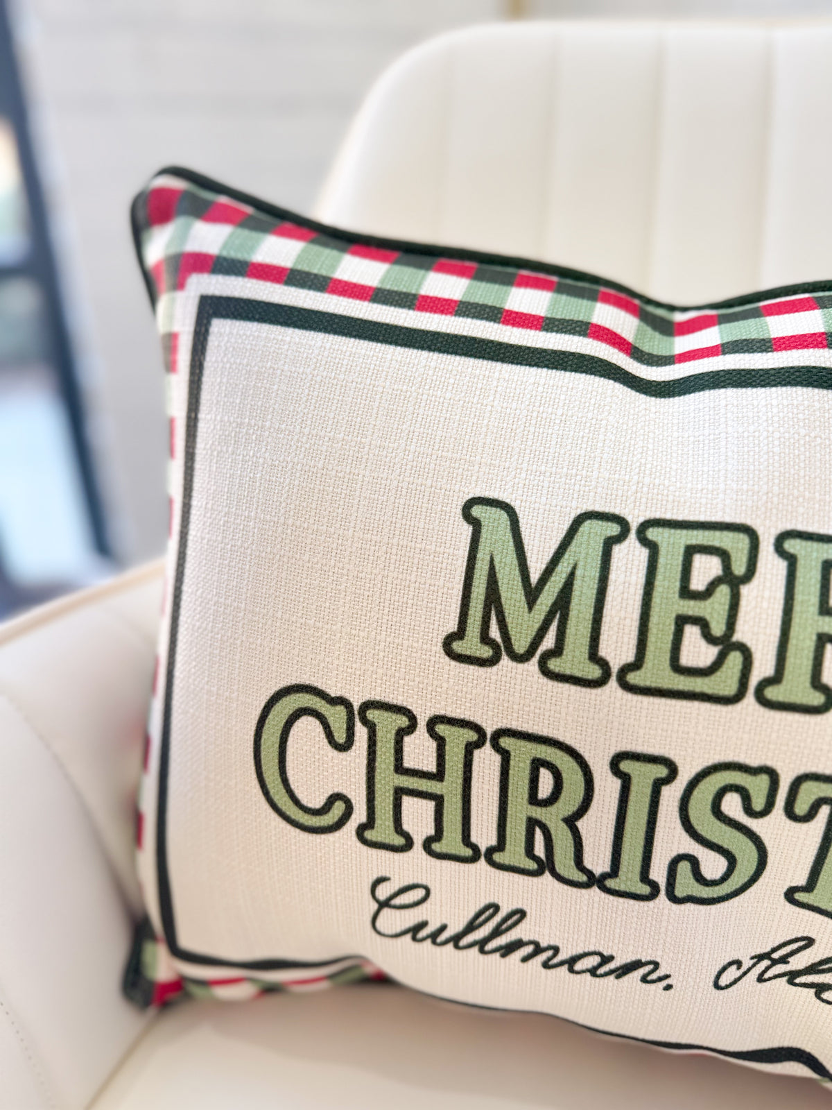 Cream pillow with red-green plaid edge; green 'MERRY CHRISTMAS' text and Cullman
