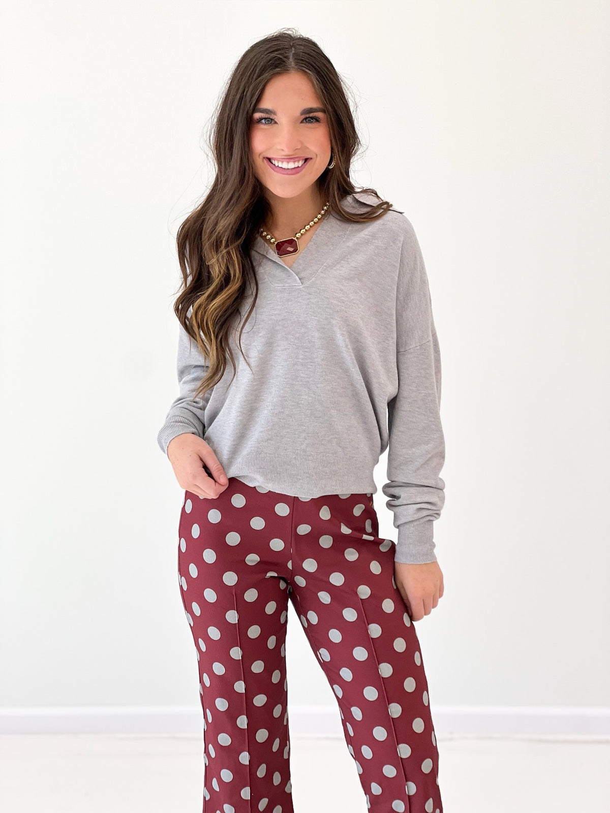 Burgundy polka dot crop flare pants with wide leg and ankle-length hem